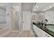 Elegant bathroom with dual sinks, granite countertops, and a tiled walk-in shower at 92 Tidy Island Blvd, Bradenton, FL 34210