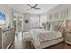 Serene bedroom with hardwood floors, neutral tones, and access to a private balcony at 92 Tidy Island Blvd, Bradenton, FL 34210