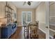 Cozy dining area with wood floors, built-in storage, and natural light from the french doors at 92 Tidy Island Blvd, Bradenton, FL 34210