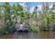 Secluded wooden dock surrounded by lush vegetation, offering a tranquil waterfront experience at 92 Tidy Island Blvd, Bradenton, FL 34210