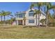 Charming home with well-manicured lawn and mature palm trees in a tropical setting at 92 Tidy Island Blvd, Bradenton, FL 34210