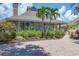 Beautiful exterior view of the clubhouse with lush landscaping, brick pathway and inviting entrance at 92 Tidy Island Blvd, Bradenton, FL 34210
