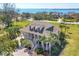 Beautiful coastal home with a large wrap-around porch, lush landscaping and scenic waterfront views at 92 Tidy Island Blvd, Bradenton, FL 34210