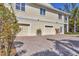 Charming home featuring a spacious three-car garage and paver driveway at 92 Tidy Island Blvd, Bradenton, FL 34210
