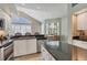Modern kitchen with granite counters, stainless steel appliances, and travertine tile floors at 92 Tidy Island Blvd, Bradenton, FL 34210