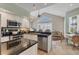 Open kitchen features granite counters, stainless appliances, and a connected breakfast nook at 92 Tidy Island Blvd, Bradenton, FL 34210