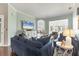 Inviting living room with a cozy sofa, bright windows, and a glimpse of the elegant dining area at 92 Tidy Island Blvd, Bradenton, FL 34210