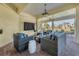 Covered patio with wicker seating, ceiling fan, and tranquil view of the outdoors at 92 Tidy Island Blvd, Bradenton, FL 34210