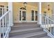Inviting front porch with elegant columns, French doors, and scenic outdoor views at 92 Tidy Island Blvd, Bradenton, FL 34210