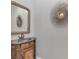 Quaint powder room featuring a decorative mirror and wood vanity at 92 Tidy Island Blvd, Bradenton, FL 34210