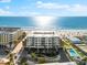 Aerial view of condo building, beach, and ocean view on a clear sunny day at 1035 Seaside Dr # 308, Sarasota, FL 34242