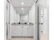 Clean bathroom featuring a vanity with drawers, a large mirror, and neutral color palette at 1035 Seaside Dr # 308, Sarasota, FL 34242