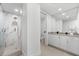 Bathroom featuring tile floors, white cabinets, stone countertops, and a glass enclosed walk-in shower at 1035 Seaside Dr # 308, Sarasota, FL 34242