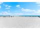 Wide view of a serene beach with a few people enjoying the sunny day at 1035 Seaside Dr # 308, Sarasota, FL 34242