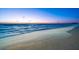 Scenic view of the beach with colorful sunset skies and gentle waves at 1035 Seaside Dr # 308, Sarasota, FL 34242