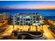 Beautiful condo exterior with beach access and city views at dusk at 1035 Seaside Dr # 308, Sarasota, FL 34242