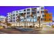 Exterior night view of the property featuring balconies and palm trees at 1035 Seaside Dr # 308, Sarasota, FL 34242