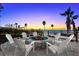 Outdoor firepit with Adirondack chairs on a brick patio with beach views at 1035 Seaside Dr # 308, Sarasota, FL 34242