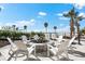 Outdoor firepit with Adirondack chairs surrounded by a brick patio with beach views at 1035 Seaside Dr # 308, Sarasota, FL 34242