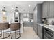 Modern kitchen boasts gray cabinets, stainless steel appliances, a wine cooler, and an island with seating at 1035 Seaside Dr # 308, Sarasota, FL 34242