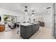 Modern kitchen with island, breakfast bar, and open floorplan to the living space at 1035 Seaside Dr # 308, Sarasota, FL 34242