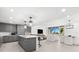 Modern open-concept living space with kitchen island, living room, and dining area at 1035 Seaside Dr # 308, Sarasota, FL 34242