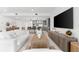 Open-concept living room with a large area rug, comfortable seating, and a view into the kitchen at 1035 Seaside Dr # 308, Sarasota, FL 34242
