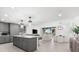 Modern open-concept living space with kitchen island, living room, and dining area at 1035 Seaside Dr # 308, Sarasota, FL 34242