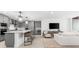 Open-concept living area with a view of the kitchen, modern appliances, and sleek countertops at 1035 Seaside Dr # 308, Sarasota, FL 34242