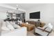 Bright living room with modern furnishings, open to the stylish kitchen with a breakfast bar at 1035 Seaside Dr # 308, Sarasota, FL 34242