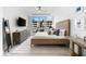 Serene main bedroom featuring a large window, comfortable bed, and stylish decor at 1035 Seaside Dr # 308, Sarasota, FL 34242