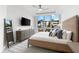 Bright bedroom with a large window, modern furnishings, and a serene atmosphere at 1035 Seaside Dr # 308, Sarasota, FL 34242