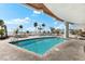 Beautiful outdoor pool with a view of the sandy beach and sun umbrellas at 1035 Seaside Dr # 308, Sarasota, FL 34242