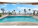 Large, inviting pool with a beach backdrop and ample lounge seating at 1035 Seaside Dr # 308, Sarasota, FL 34242