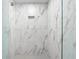 Modern shower with rainfall head, bench, and tiled with Carrara marble at 1035 Seaside Dr # 308, Sarasota, FL 34242