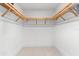Empty walk-in closet with custom shelving and ample storage space, ready for organization at 1035 Seaside Dr # 308, Sarasota, FL 34242