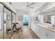 Bathroom with dual sinks, large mirrors and sliding closet doors at 1055 Gulf Of Mexico Dr # 405, Longboat Key, FL 34228
