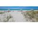Inviting beach with pristine white sand, comfortable lounge chairs, and umbrellas for a serene and relaxing beach experience at 1055 Gulf Of Mexico Dr # 405, Longboat Key, FL 34228