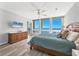 Bedroom featuring ocean view and light laminate flooring at 1055 Gulf Of Mexico Dr # 405, Longboat Key, FL 34228