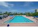 Large community pool perfect for lap swimming, surrounded by lounge chairs and umbrellas at Beachplace at 1055 Gulf Of Mexico Dr # 405, Longboat Key, FL 34228