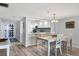 Bright dining room with a table, chairs, and a view to the updated kitchen with stainless appliances at 1055 Gulf Of Mexico Dr # 405, Longboat Key, FL 34228