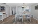 Open dining room featuring a modern table set and easy access to the kitchen and hallway at 1055 Gulf Of Mexico Dr # 405, Longboat Key, FL 34228