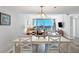 Cozy dining room next to the living room boasting seating for four with balcony access at 1055 Gulf Of Mexico Dr # 405, Longboat Key, FL 34228