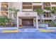 Inviting building entrance featuring clean lines, a covered entryway and manicured greenery at 1055 Gulf Of Mexico Dr # 405, Longboat Key, FL 34228