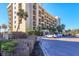 Stunning exterior shot of a multi-story condo building surrounded by lush landscaping at 1055 Gulf Of Mexico Dr # 405, Longboat Key, FL 34228