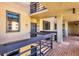 Exterior hallway with brick flooring and iron railings, leading to multiple apartment entrances at 1055 Gulf Of Mexico Dr # 405, Longboat Key, FL 34228