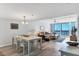 Bright living room features a dining area and sliding doors leading to a balcony with ocean views at 1055 Gulf Of Mexico Dr # 405, Longboat Key, FL 34228