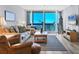Bright living room with a comfortable seating area and large windows offering beautiful ocean views at 1055 Gulf Of Mexico Dr # 405, Longboat Key, FL 34228