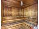 Classic wooden sauna room with tiered seating and overhead lighting, perfect for relaxation at 1055 Gulf Of Mexico Dr # 405, Longboat Key, FL 34228
