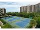 Aerial view of Beachplace's tennis courts, with lush landscaping and the condo buildings in the background at 1055 Gulf Of Mexico Dr # 405, Longboat Key, FL 34228